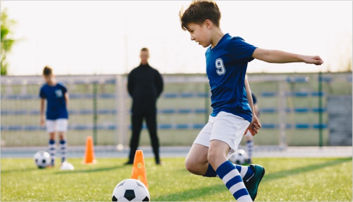 Kid dribbling during u7 soccer training