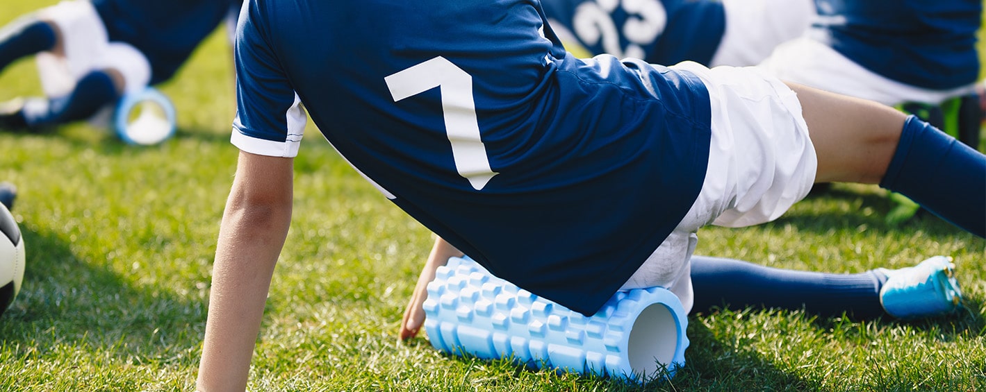 Soccer player Foam Rolling during training 