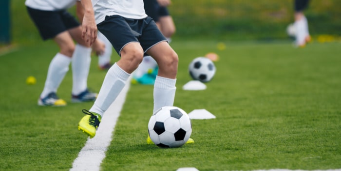 Young soccer player developing skill techniques