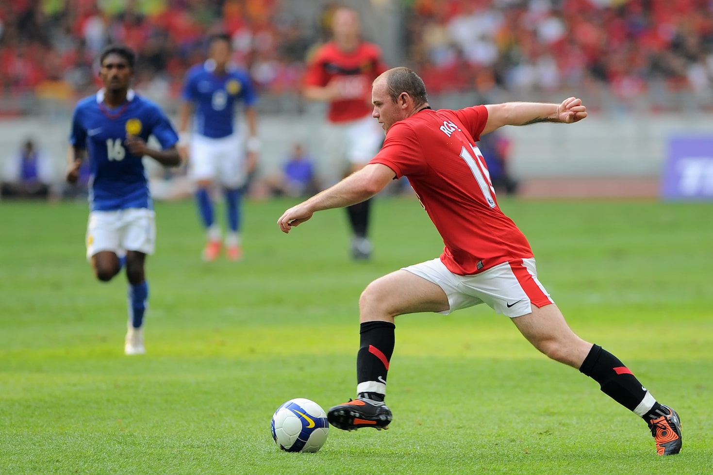 Wayne Rooney dribbling as number 10 in soccer
