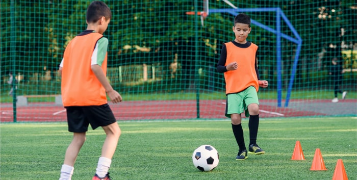 Two players training how to pass a soccer ball to each other