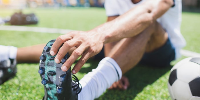 Player stretching before soccer training