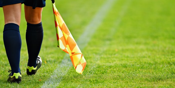 Assistant referee moving along the sideline during a soccer match